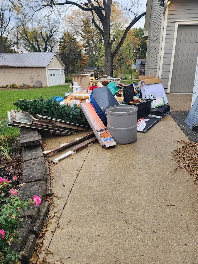 Dumpster being loaded with debris for Roofing Dumpster Rental in Bloomington